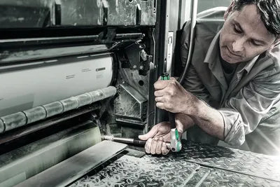 Technician tightening a fastener on machinery with a Wera ratchet