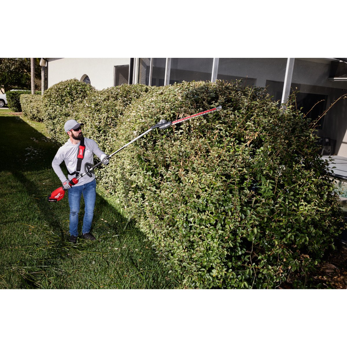 Milwaukee 3035-20 M18 FUEL™ Extended Pole Articulating Hedge Trimmer - in use