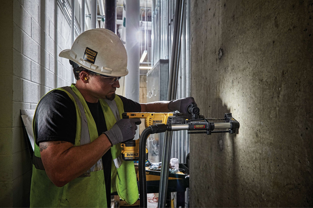 Worker drilling concrete with a DEWALT SDS-plus rotary hammer