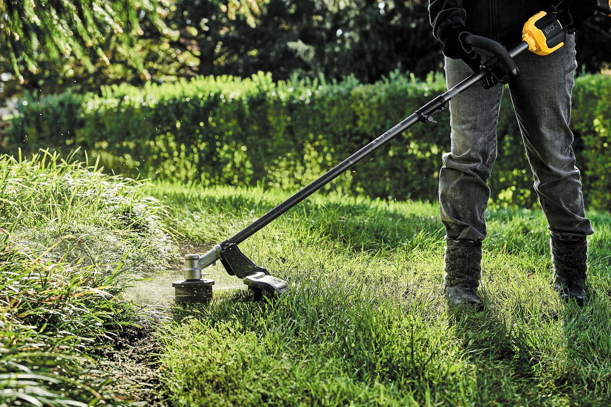 DEWALT DCST972B 60V MAX 17 in. Brushless Attachment Capable String Trimmer (Tool Only) - in use