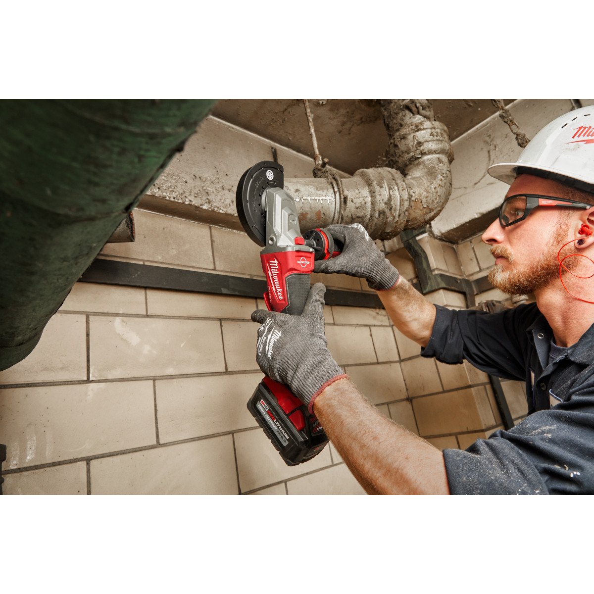 Milwaukee 2886-20 M18 FUEL™ 5" Flathead Braking Grinder, Paddle Switch No-Lock - in use