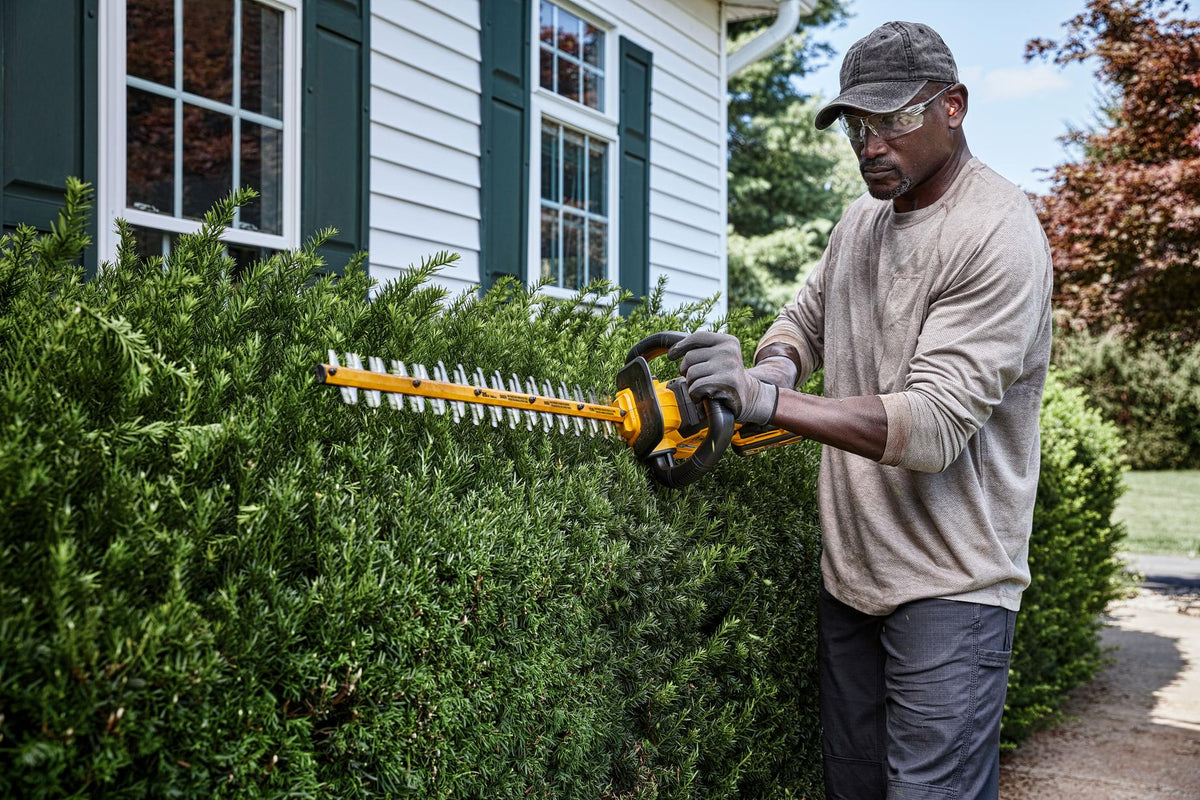 DEWALT DCHT870T1 60V Hedge Trimmer W/ 2Ah Battery - in use