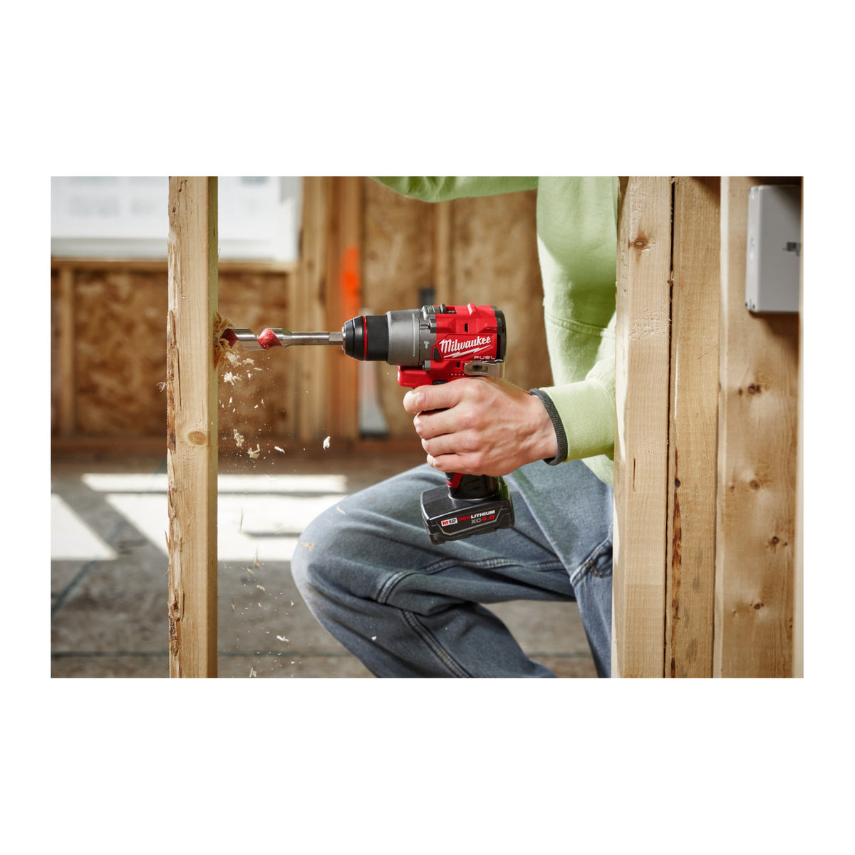 Milwaukee M12 FUEL 1/2" Hammer Drill/Driver 3404-20 drilling through a wood stud