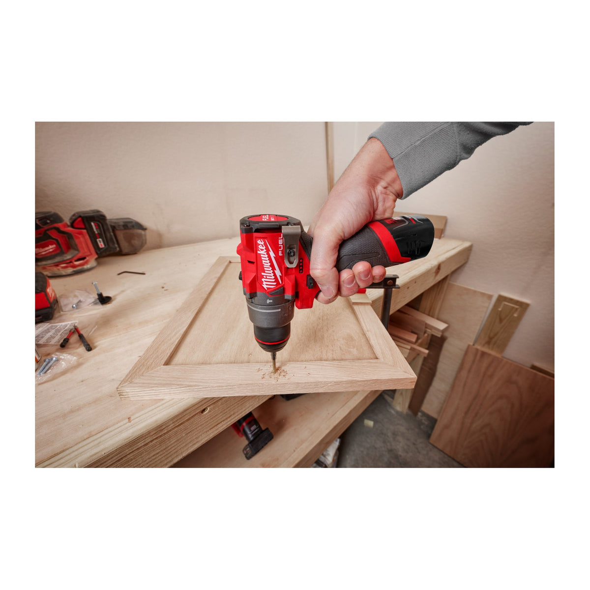 Milwaukee M12 FUEL 1/2" Hammer Drill/Driver 3404-20 driving screws into a cabinet door