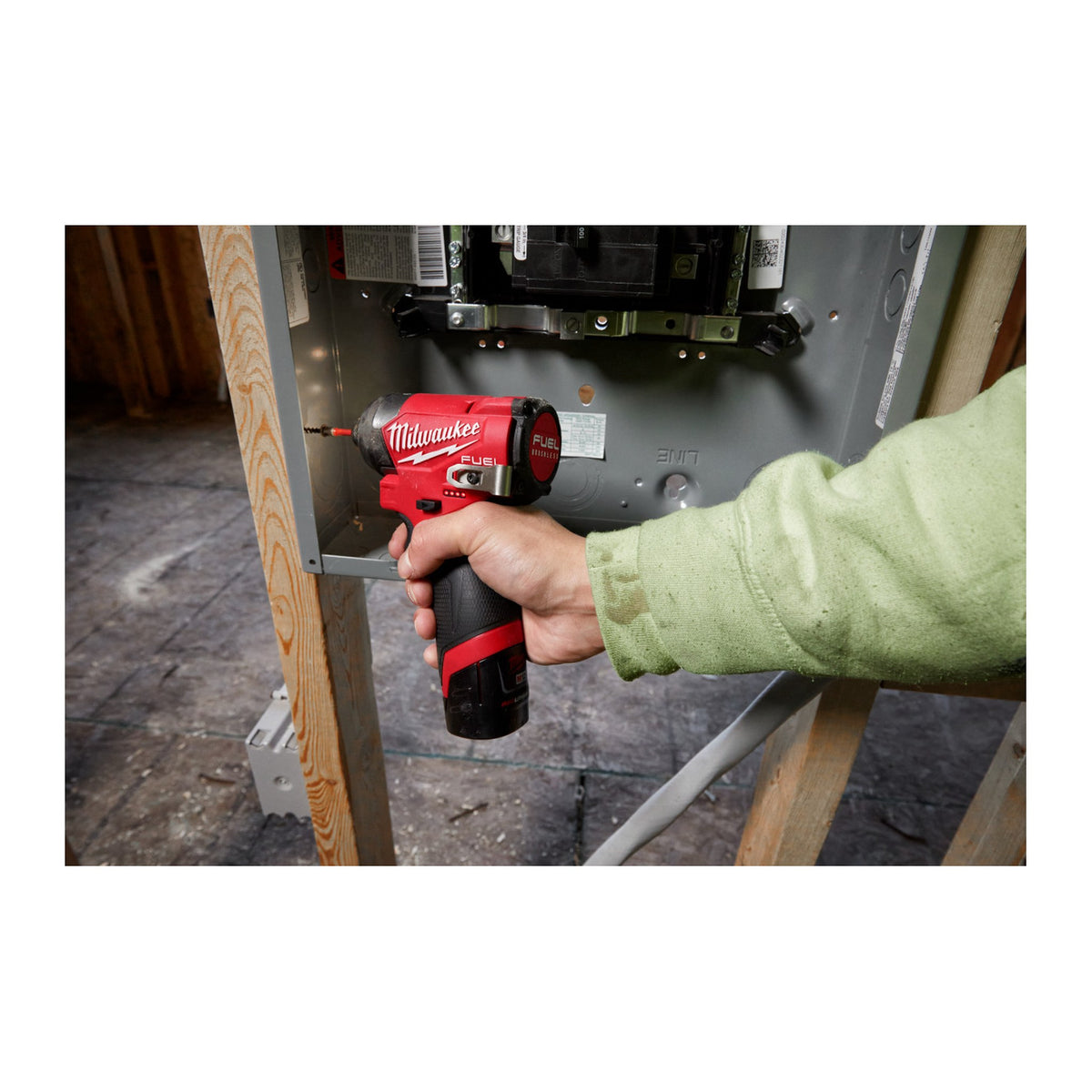 Milwaukee M12 FUEL 1/4" Hex Impact Driver 3453-20 driving a fastener inside a wall cavity
