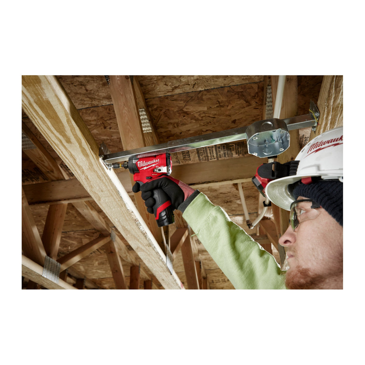 Milwaukee M12 FUEL 1/4" Hex Impact Driver 3453-20 fastening overhead between ceiling joists