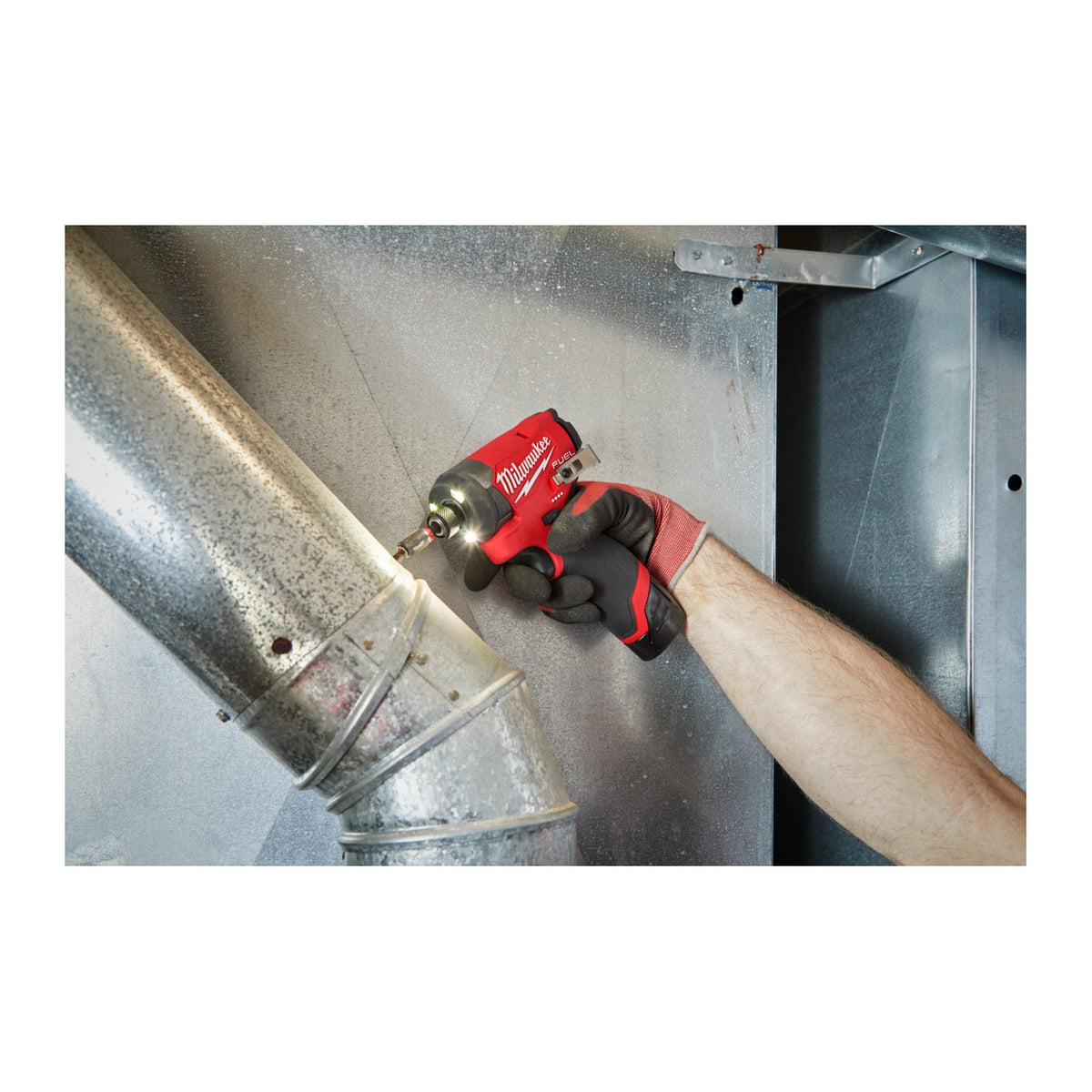 Milwaukee M12 FUEL 1/4" Hex Impact Driver 3453-20 fastening a strap on HVAC ductwork