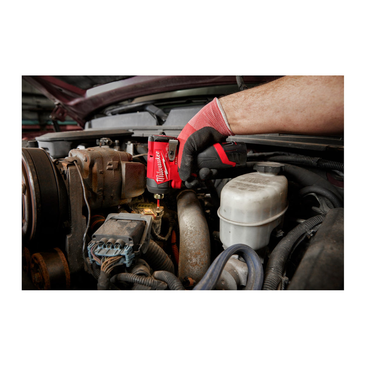 Milwaukee M12 FUEL 1/4" Hex Impact Driver 3453-20 working in a tight engine bay