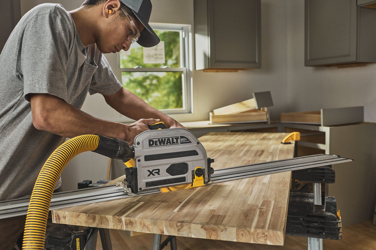 DEWALT DCS525ST in use cutting on track in shop