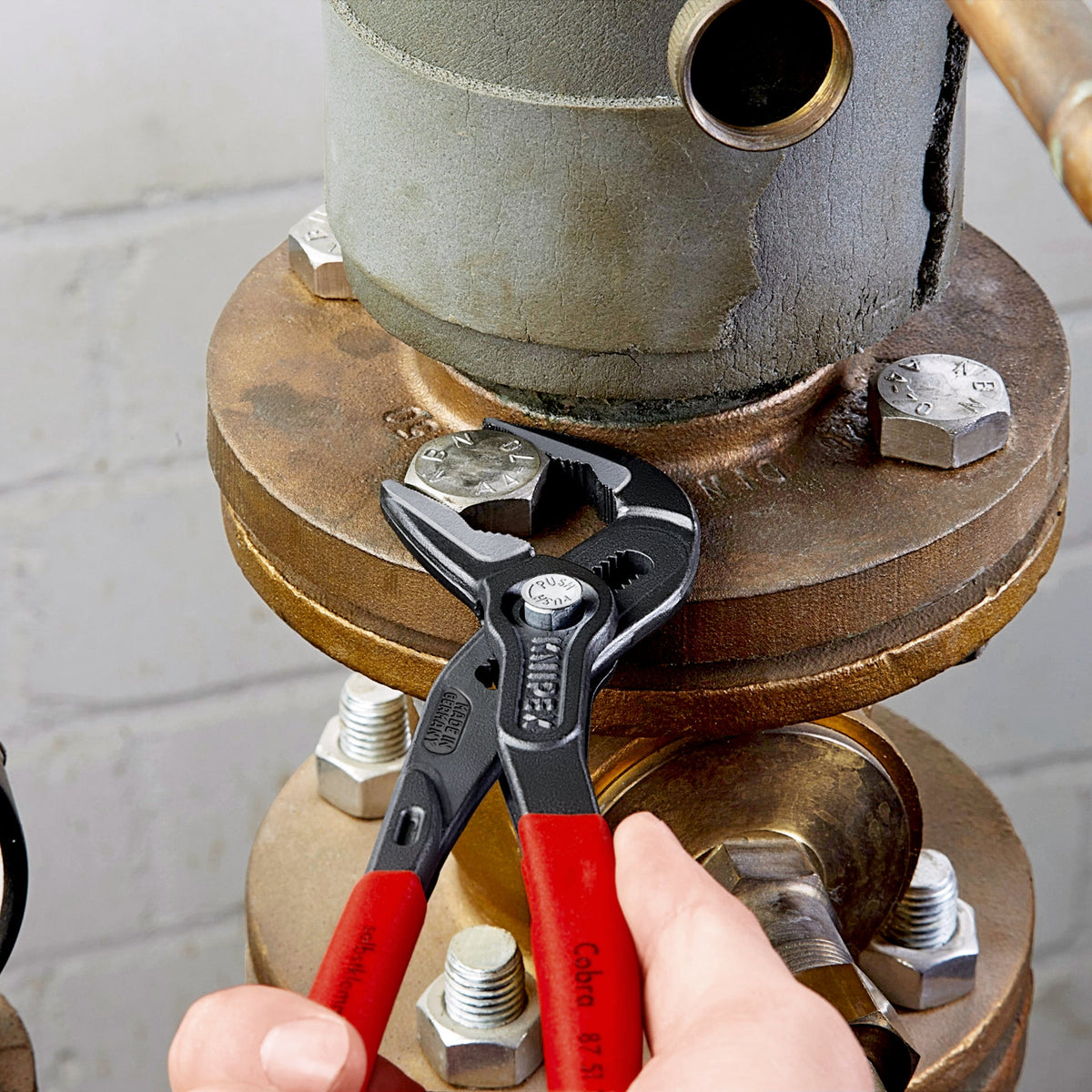 Knipex Cobra pliers on a pipe flange