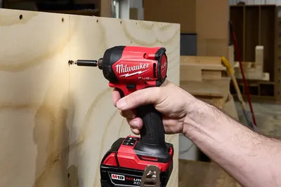Driving a screw into plywood with a Milwaukee M18 FUEL impact driver